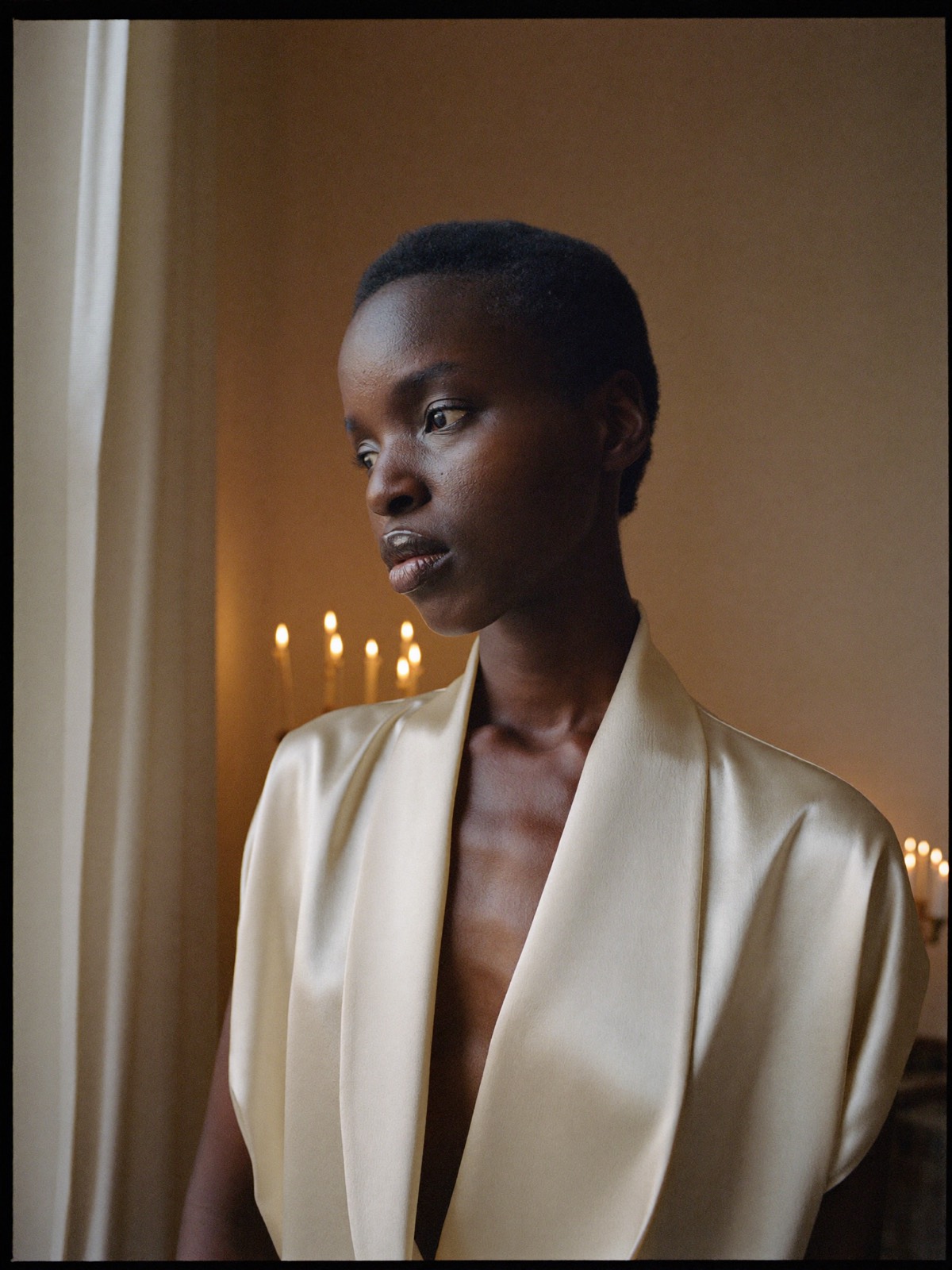 Amara, portrait in a warm candlelit interior